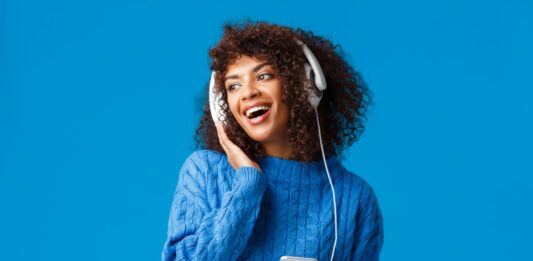 Listening para iniciantes: 10 dicas para treinar a escuta do inglês para quem está começando Mulher praticando Listening para iniciantes: